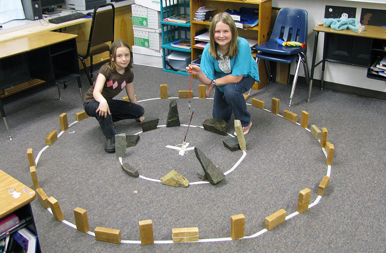 Two students with their blocks made into Stonehenge